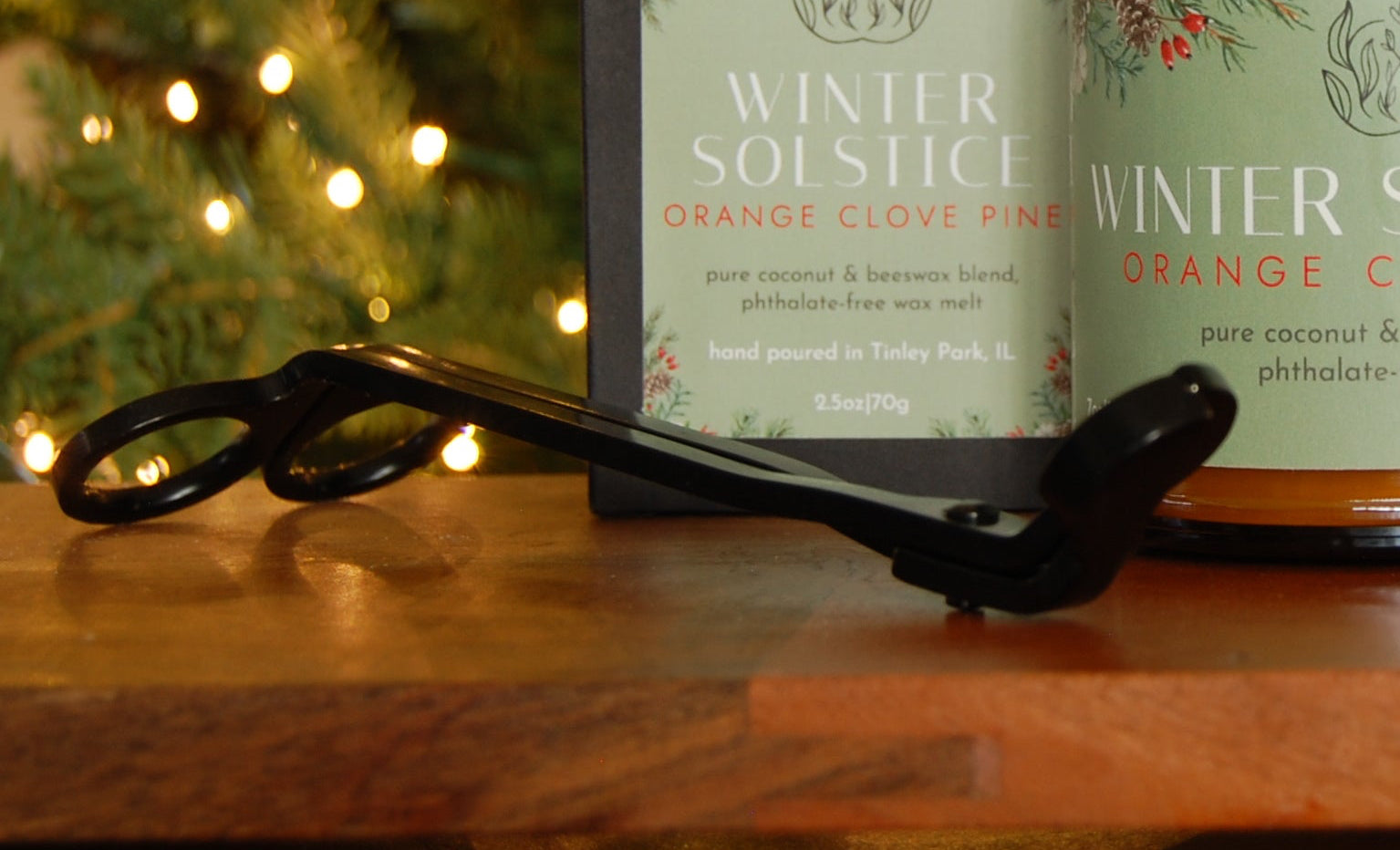 Wick Trimmer focal point with candle and packaging with 'Winter Solstice' branding against a festive background