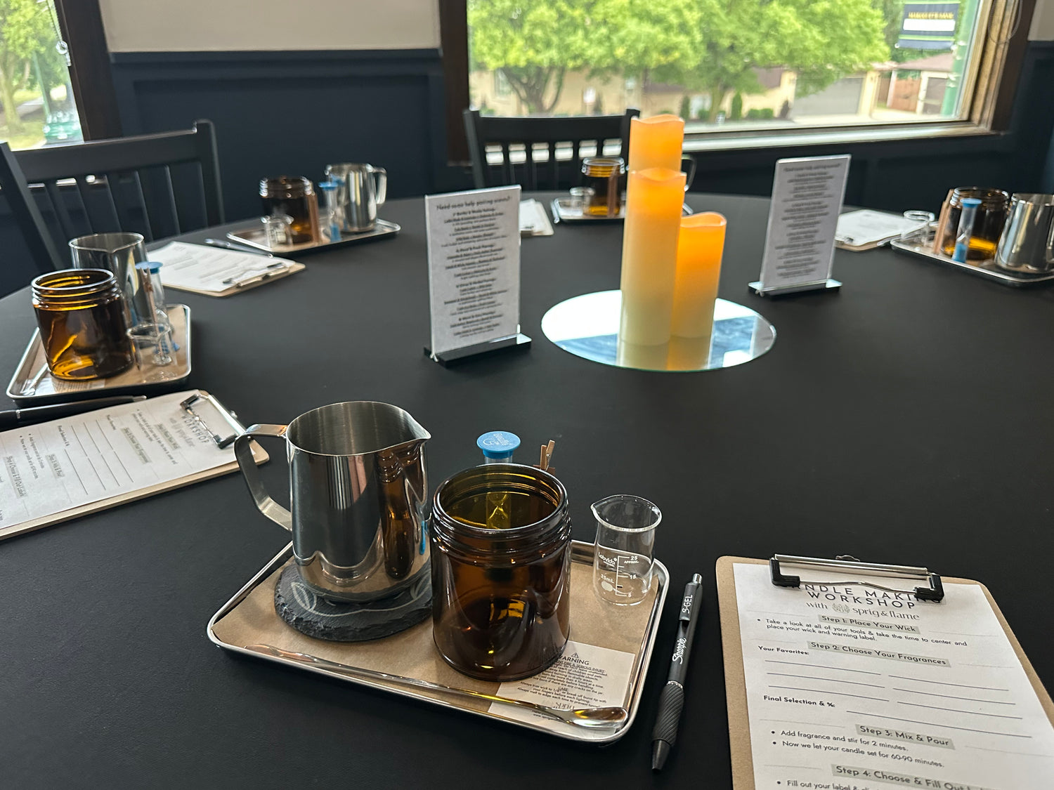 Table set for candle making including all the supplies and tools.